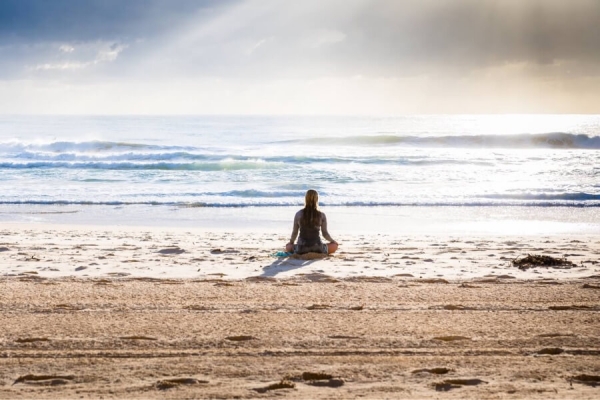 woman meditate on an ocean shore