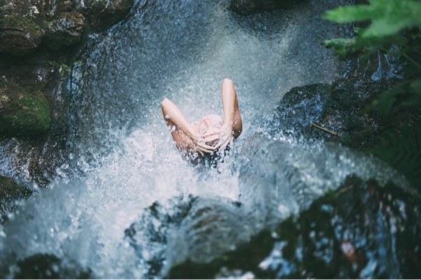 woman in a waterfall
