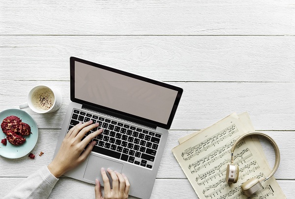 laptop on a table with cup of coffee